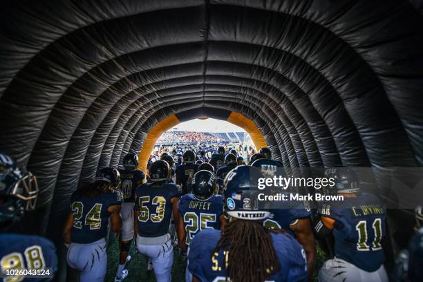 Golden Panthers run through the tunnel before the game against the Indiana Hoosiers at Ricardo Silva Stadium on September 1, 2018 in Miami, Florida.