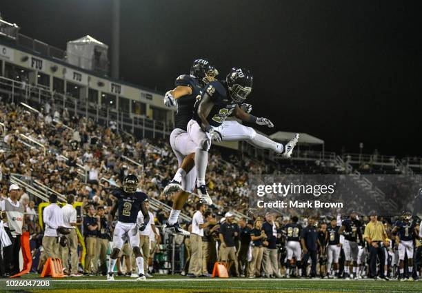 Emmanuel Lubin and Shawndarrius Phillips of the FIU Golden Panthers celebrate a touchdown during the second half against the Indiana Hoosiers at...