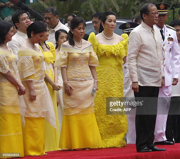 Newly inaugurated Philippine President Benigno Aquino stands beside his sisters Viel, Ballsy, Pinky and Kris during a military honor ceremony upon...