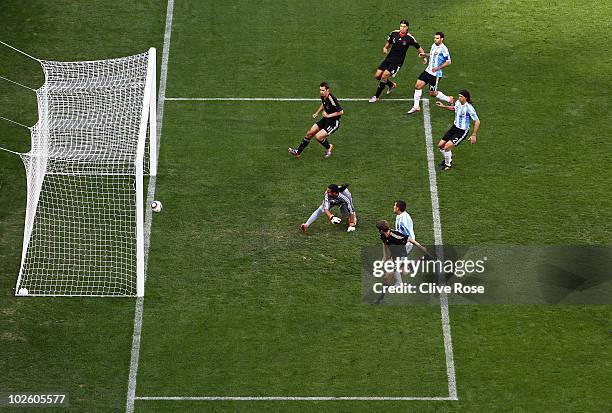 Thomas Mueller of Germany scores the opening goal past Sergio Romero of Argentina during the 2010 FIFA World Cup South Africa Quarter Final match...