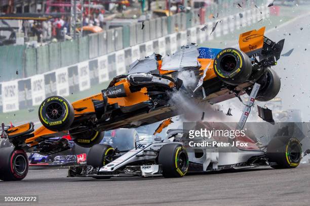 Fernando Alonso of McLaren and Spain crashes over the top of Charles Leclerc of Alfa Romeo Sauber and France during the Formula One Grand Prix of...