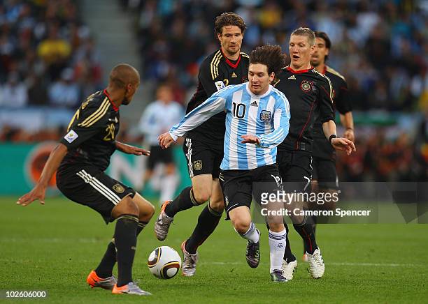 Lionel Messi of Argentina is closed down by Jerome Boateng and Bastian Schweinsteiger of Germany during the 2010 FIFA World Cup South Africa Quarter...