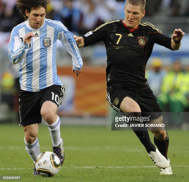 Argentina's striker Lionel Messi fights for the ball with Germany's midfielder Bastian Schweinsteiger during the 2010 World Cup quarter-final match...