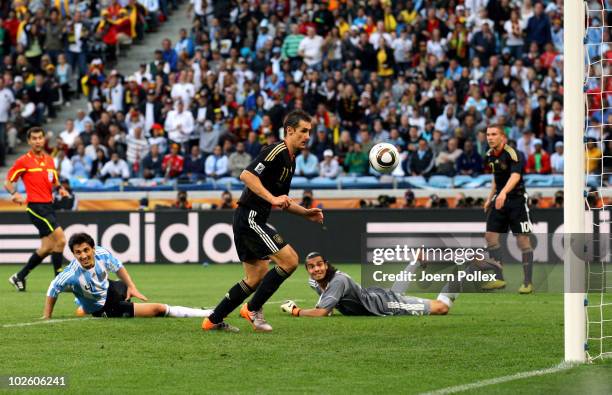 Miroslav Klose of Germany scores his team's second goal past Sergio Romero of Argentina during the 2010 FIFA World Cup South Africa Quarter Final...