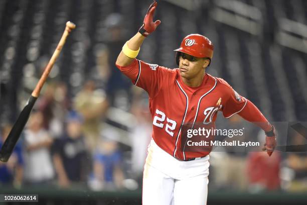Juan Soto of the Washington Nationals throws the bat after singling in two runs in the eighth inning during a baseball game against the Milwaukee...