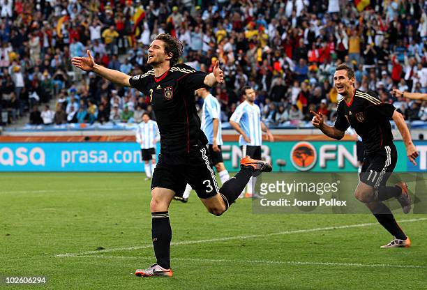 Arne Friedrich of Germany celebrates scoring his team's third goal during the 2010 FIFA World Cup South Africa Quarter Final match between Argentina...