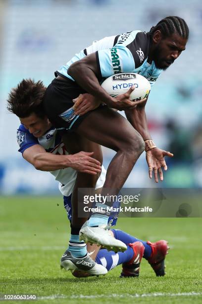 Edrick Lee of the Sharks is tackled during the round 25 NRL match between the Canterbury Bulldogs and the Cronulla Sharks at ANZ Stadium on September...