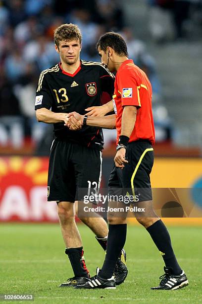 Thomas Mueller of Germany shakes hands with Referee Ravshan Irmatov after winning the 2010 FIFA World Cup South Africa Quarter Final match between...