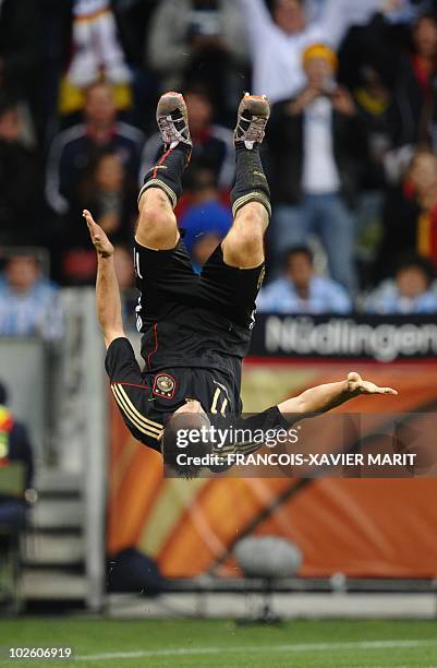 Germany's striker Miroslav Klose celebrates scoring goal number four by doing a flip during the 2010 World Cup quarter-final football match Argentina...