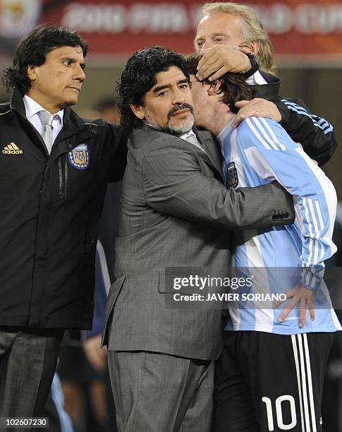 Argentina's coach Diego Maradona hugs Argentina's striker Lionel Messi after the 2010 World Cup quarter final Argentina vs Germany on July 3, 2010 at...