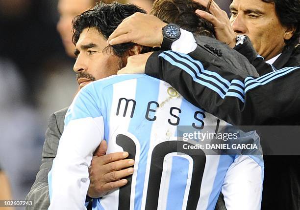 Argentina's coach Diego Maradona hugs Argentina's striker Lionel Messi after the 2010 World Cup quarter final Argentina vs Germany on July 3, 2010 at...