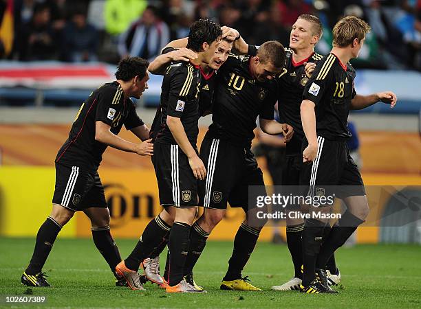 The Germany team celebrate with Miroslav Klose after he scores his team's second goal during the 2010 FIFA World Cup South Africa Quarter Final match...