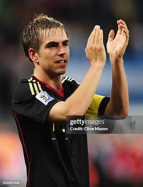 Captain Philipp Lahm of Germany celebrates victory and progress to the semi finals during the 2010 FIFA World Cup South Africa Quarter Final match...