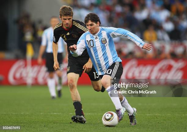 Lionel Messi of Argentina is pursued by Thomas Mueller of Germany during the 2010 FIFA World Cup South Africa Quarter Final match between Argentina...