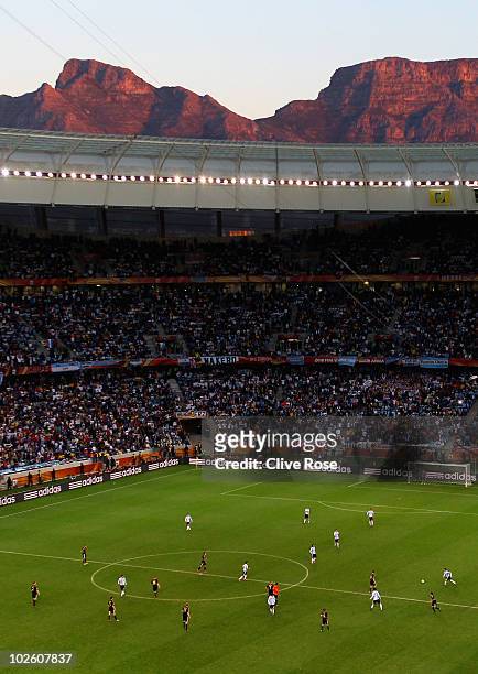 General view of action showing Table Mountain at sunset in the background during the 2010 FIFA World Cup South Africa Quarter Final match between...