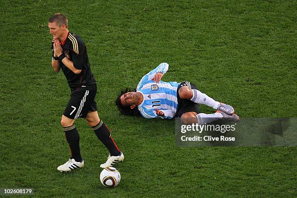 Bastian Schweinsteiger of Germany walks away from a challenge on Carlos Tevez of Argentina during the 2010 FIFA World Cup South Africa Quarter Final...