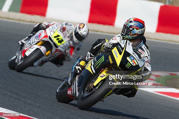 Colin Edwards of USA and Monster Yamaha Tech 3 leads Randy De Puniet of France and LCR Honda MotoGP during the qualifying practice session of MotoGP...