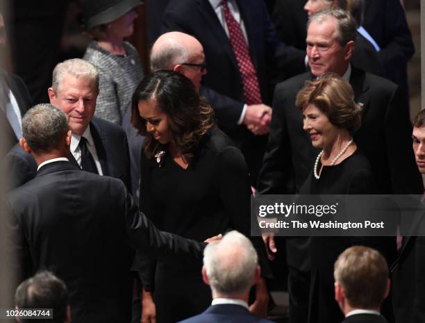 Former Presidents Barach Obama and George Bush with their wives Michelle and Barbara talks with former VP Al Gore at the funeral service at the...