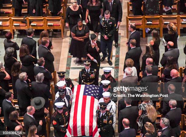 Cindy McCain wipes away tears as she follows the casket out of thefuneral service for her husband at the National Cathedral for Sen. John S. McCain ,...