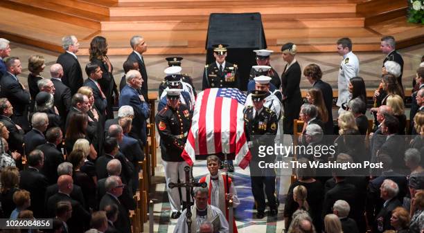 Presidents Bill Clinton, George Bush and Barack Obama look on with the family as the casket is taken out following the funeral service at the...