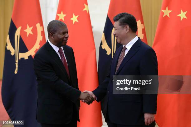 Angola's President Joao Lourenco, left, shakes hands with Chinese President Xi Jinping before proceed to their bilateral meeting at the Great Hall of...