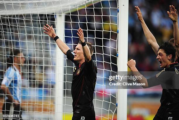 Bastian Schweinsteiger celebrates the third goal by Arne Friedrich of Germany during the 2010 FIFA World Cup South Africa Quarter Final match between...