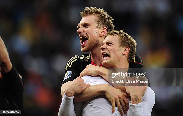 Per Mertesacker and Manuel Neuer of Germany celebrate victory following the 2010 FIFA World Cup South Africa Quarter Final match between Argentina...