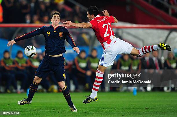 Fernando Torres of Spain and Antolin Alcaraz of Paraguay challenge for the ball during the 2010 FIFA World Cup South Africa Quarter Final match...