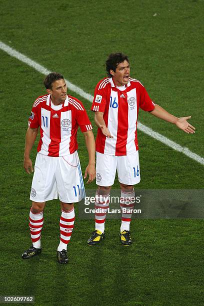 Jonathan Santana and Cristian Riveros of Paraguay react to a decision during the 2010 FIFA World Cup South Africa Quarter Final match between...