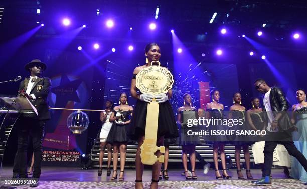 Ivorian singer Serge Beynaud , arrives on stage to receive his award on September 2, 2018 during the first edition of popular Ivorian dance music...