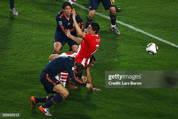 Gerard Pique of Spain pulls down Oscar Cardozo of Paraguay in the penalty area and gives away a penalty kick during the 2010 FIFA World Cup South...