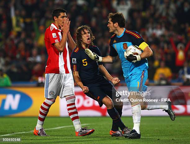 Carles Puyol of Spain celebrates as Iker Casillas saves a penalty by Oscar Cardozo of Paraguay during the 2010 FIFA World Cup South Africa Quarter...