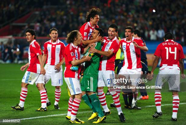 Justo Villar of Paraguay celebrates with team mates after he saves the second penalty kick from Xabi Alonso of Spain during the 2010 FIFA World Cup...