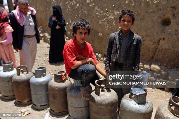 Yemenis wait for gas supply with their to empty cylinders amid increasing shortages in the Yemeni capital Sanaa, on September 2, 2018.