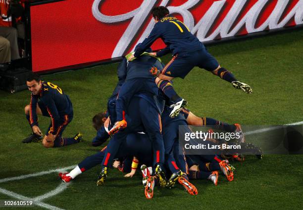 The Spain team celebrate with David Villa after he scores his side's first goal during the 2010 FIFA World Cup South Africa Quarter Final match...