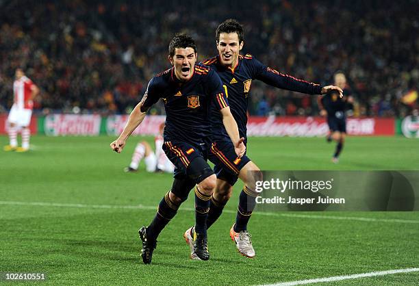 David Villa of Spain celebrates after he scores his side's first goal with team mate Francesc Fabregas during the 2010 FIFA World Cup South Africa...