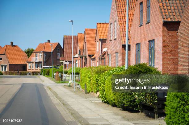 red brick houses. street in the little town nakskov on lolland. nice weather with blue sky. - denmark stockfoto's en -beelden