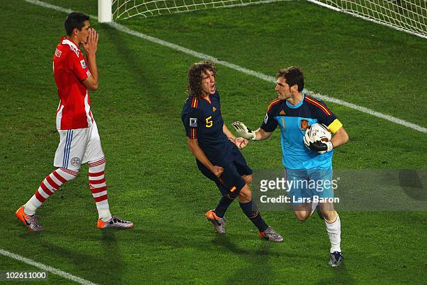 Iker Casillas of Spain celebrates with team mate Carles Puyol after saving the penalty kick from Oscar Cardozo of Paraguay during the 2010 FIFA World...