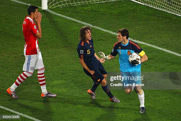 Iker Casillas of Spain celebrates with team mate Carles Puyol after saving the penalty kick from Oscar Cardozo of Paraguay during the 2010 FIFA World...