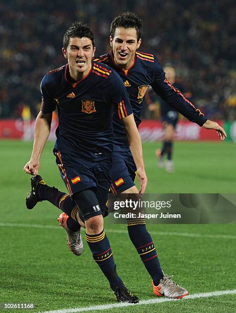 David Villa of Spain celebrates after he scores his side's first goal with team mate Francesc Fabregas during the 2010 FIFA World Cup South Africa...