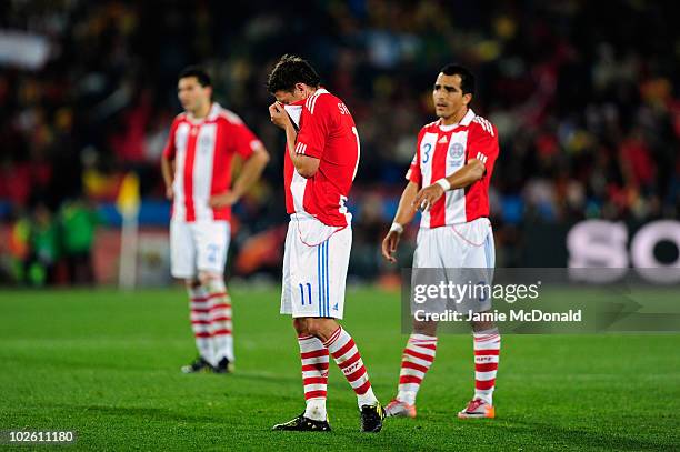 Dejected Jonathan Santana and Claudio Morel of Paraguay after being knocked out of the tournament during the 2010 FIFA World Cup South Africa Quarter...