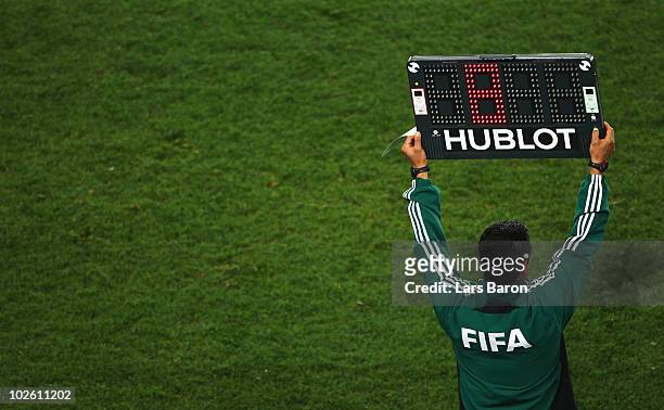Match official holds up an electronic board to signal a substitution during the 2010 FIFA World Cup South Africa Quarter Final match between Paraguay...