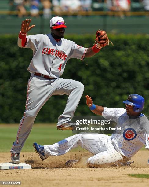 Brandon Phillips of the Cincinnati Reds steps on second base to force out a sliding Marlon Byrd of the Chicago Cubs at Wrigley Field on July 3, 2010...