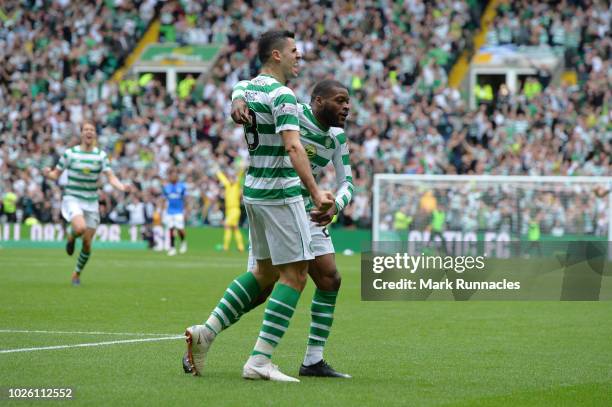 Olivier Ntcham of Celtic celebrates with teammate Tomas Rogic after scoring his team's first goal during the Scottish Premier League match between...