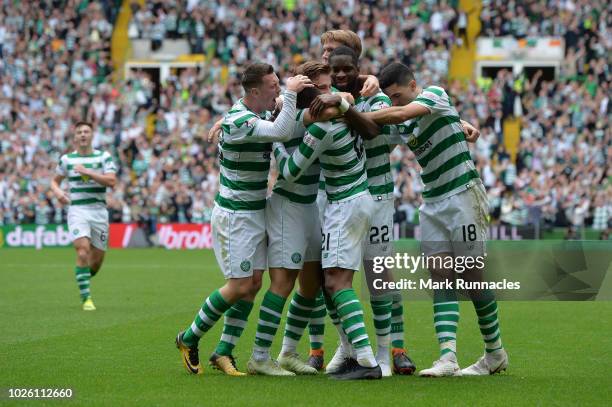Olivier Ntcham of Celtic celebrates with teammates after scoring his team's first goal during the Scottish Premier League match between Celtic and...