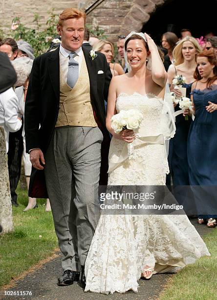 Mark Dyer and Amanda Kline leave St. Edmund's Church after their wedding on July 3, 2010 in Abergavenny, Wales.