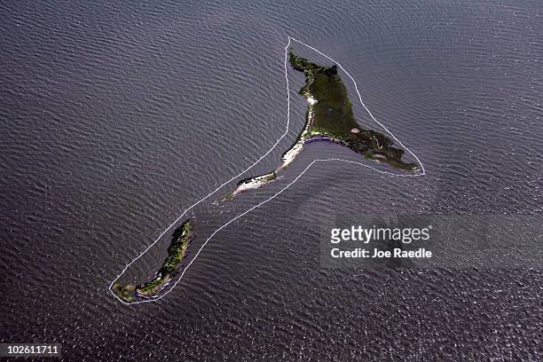 Absorbent material is seen ringing an island as efforts are made to keep the oil from the Deepwater Horizon spill off the land on July 3, 2010 near...