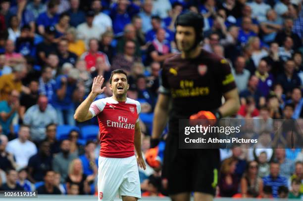Sokratis Papastathopoulos shouts instructions to Petr Cech of Arsenal during the Premier League match between Cardiff City and Arsenal at Cardiff...