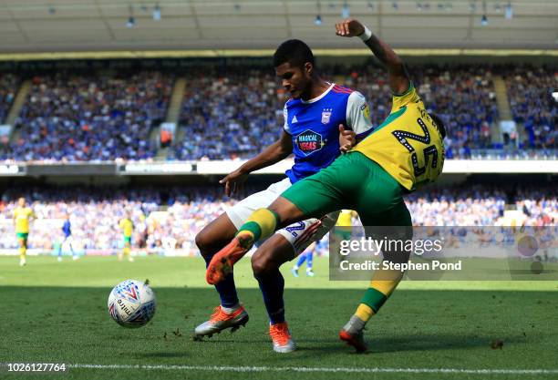 Jordan Spence of Ipswich Town holds off Onel Hernández of Norwich City during the Sky Bet Championship match between Ipswich Town and Norwich City at...