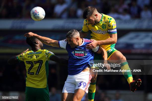 Alexander Tettey and Grant Hanley of Norwich City battle for the ball with Jonathan Walters of Ipswich Town during the Sky Bet Championship match...